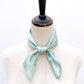 Light blue mulberry silk bandana tied around a mannequin neck on a white background