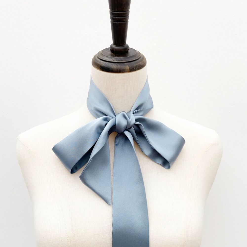 dusty blue mulberry silk satin skinny scarf tied around mannequin's neck