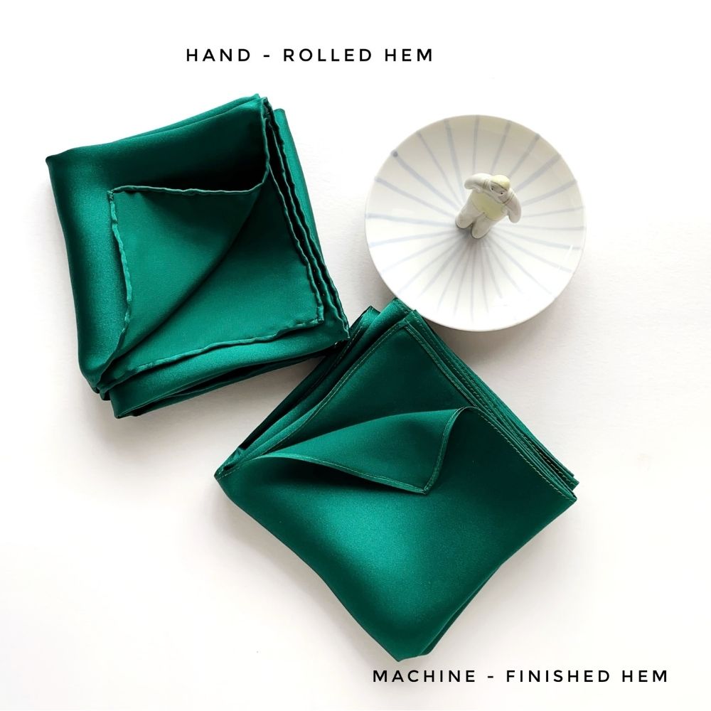 Hand-rolled and machine-finished hems displayed in emerald green silk