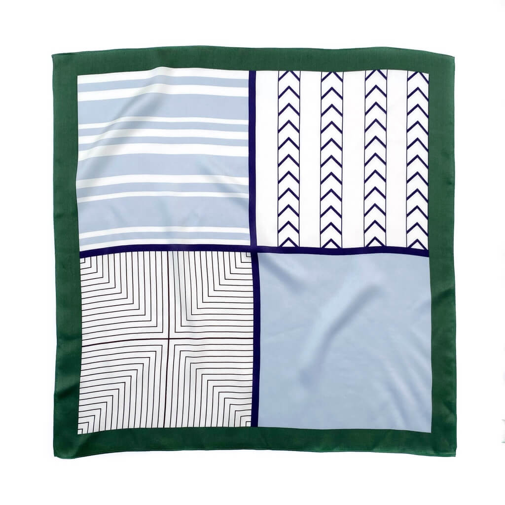 flat blue white geometric pattern mulberry silk square scarf with green border on a white background