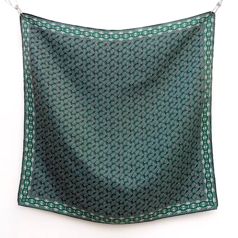 Green paisley patterned mulberry silk twill square scarf on a white background