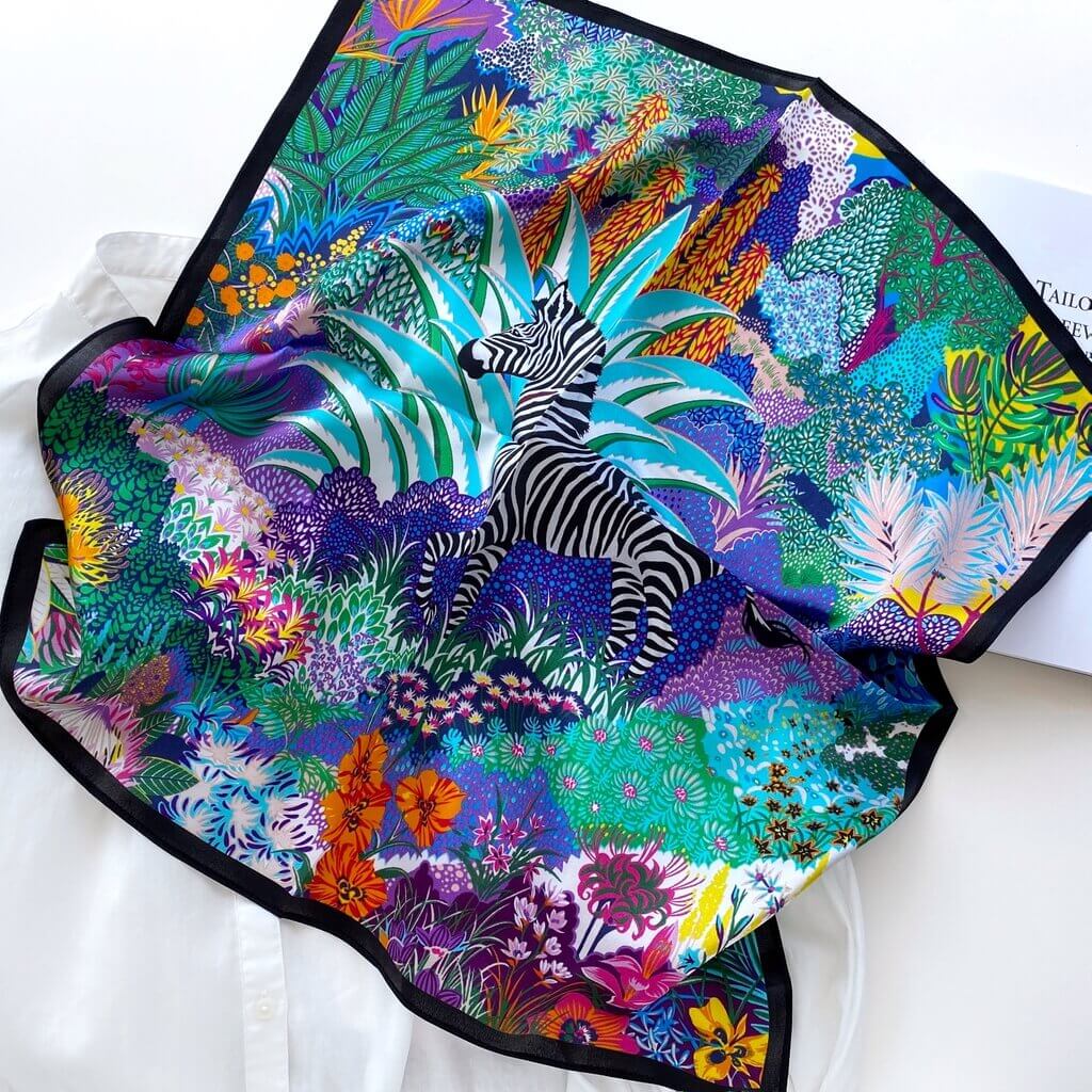 Colourful blue purple mulberry silk square scarf with zebra design and tropical patterns on a white background