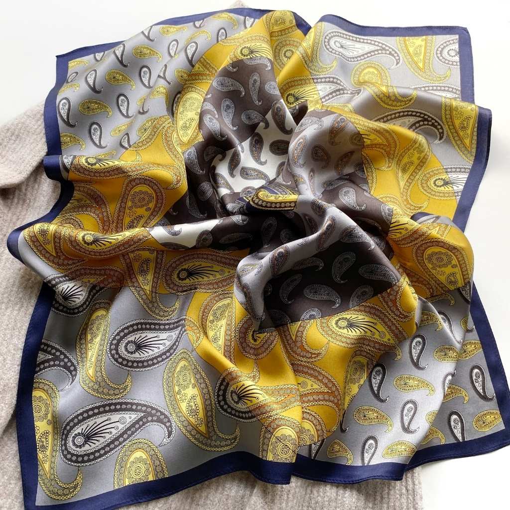 flat displayed mulberry silk square scarf with paisley print in yellow, grey and silver