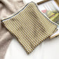 yellow brown mulberry silk square scarf with geometric design on a light surface