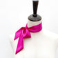 bright fuchsia mulberry silk satin skinny scarf tied around mannequin's neck