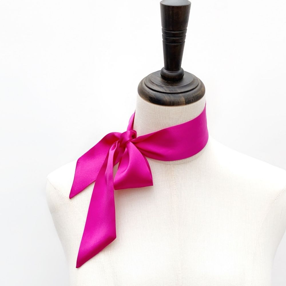 bright fuchsia mulberry silk satin skinny scarf tied around mannequin's neck