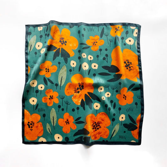 53cm square Floral patterned mulberry silk scarf with orange flowers on a teal green background laid flat on the white background