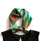 green red yellow mulberry silk neckerchief tied around a black dress on a white background
