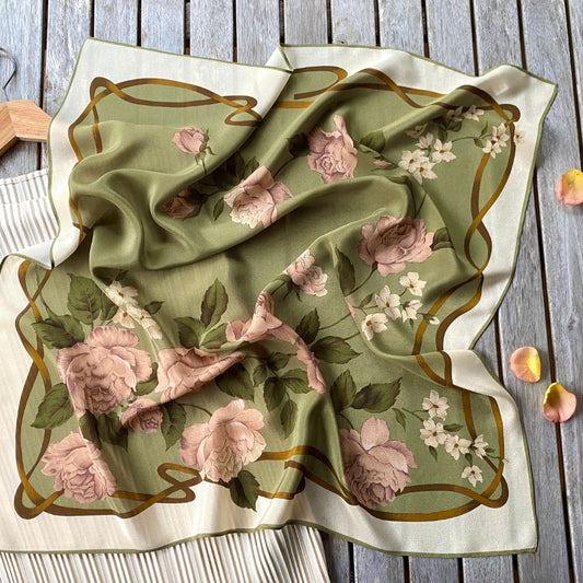 Floral patterned fabric on a wooden surface with scattered rose petals.
