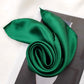 Jade Green silk satin scarf styled on a magazine with soft sheen