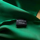 Close-up of Jade Green Mulberry silk satin fabric with River Minami label