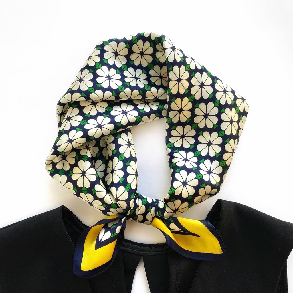 Floral patterned mulberry silk neckerchief with yellow accents on a white background