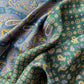 Close-up of green mulberry silk square scarf with intricate paisley pattern