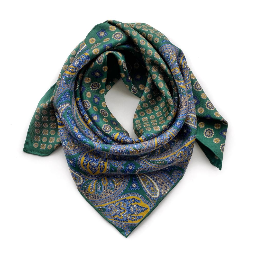 Green and blue paisley patterned mulberry silk square scarf on a white background