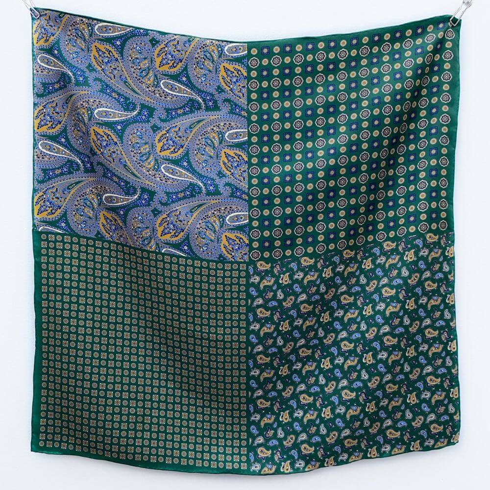 Green mulberry silk square scarf  with paisley and geometric patterns on a white background