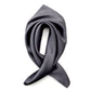 Slate grey silk satin square scarf arranged in a soft folded shape on a white background.
