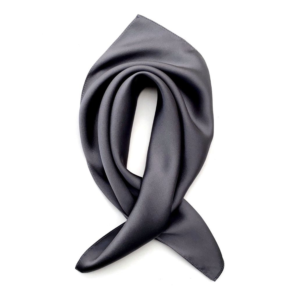 Slate grey silk satin square scarf arranged in a soft folded shape on a white background.
