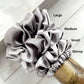 Set of grey mulberry silk satin scrunchies labeled 'Large', 'Medium', 'Small', and 'Skinny' on a wooden surface.