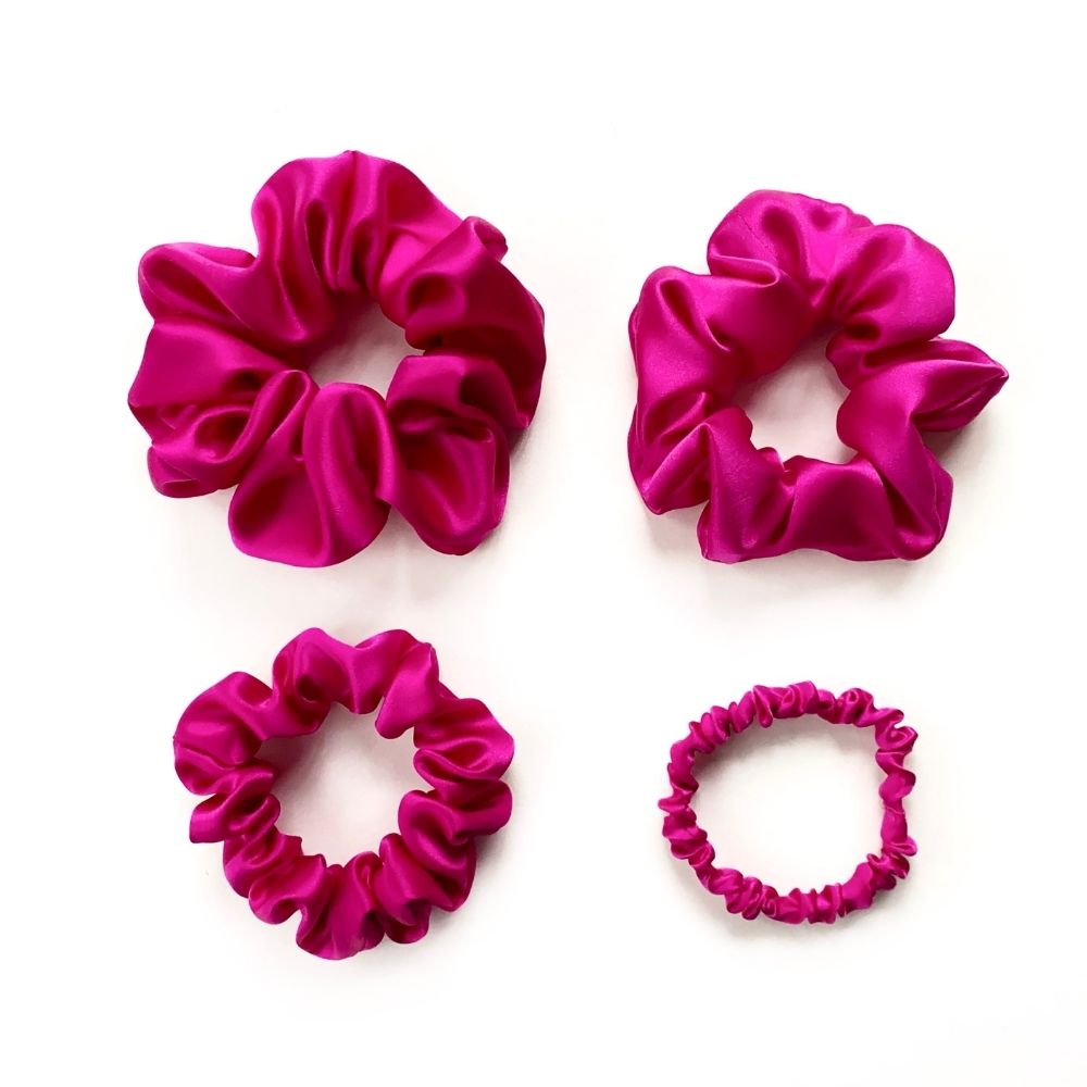 set of hot pink pure mulberry silk satin scrunchies and hair ties on the white background