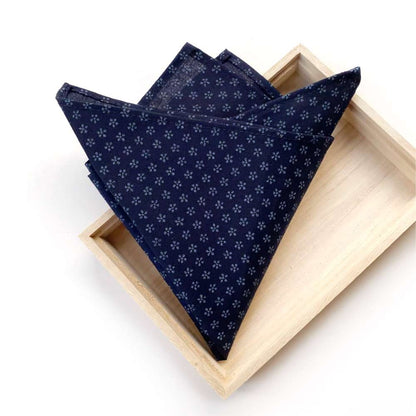 Navy blue Japanese cotton pocket square in a wooden box on a white background