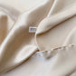 Close-up of Pearl Cream silk satin fabric showing smooth sheen
