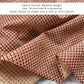 Close-up of red Kanoko Japanese cotton fabric, medium-weight structured cotton with fawn-spot pattern