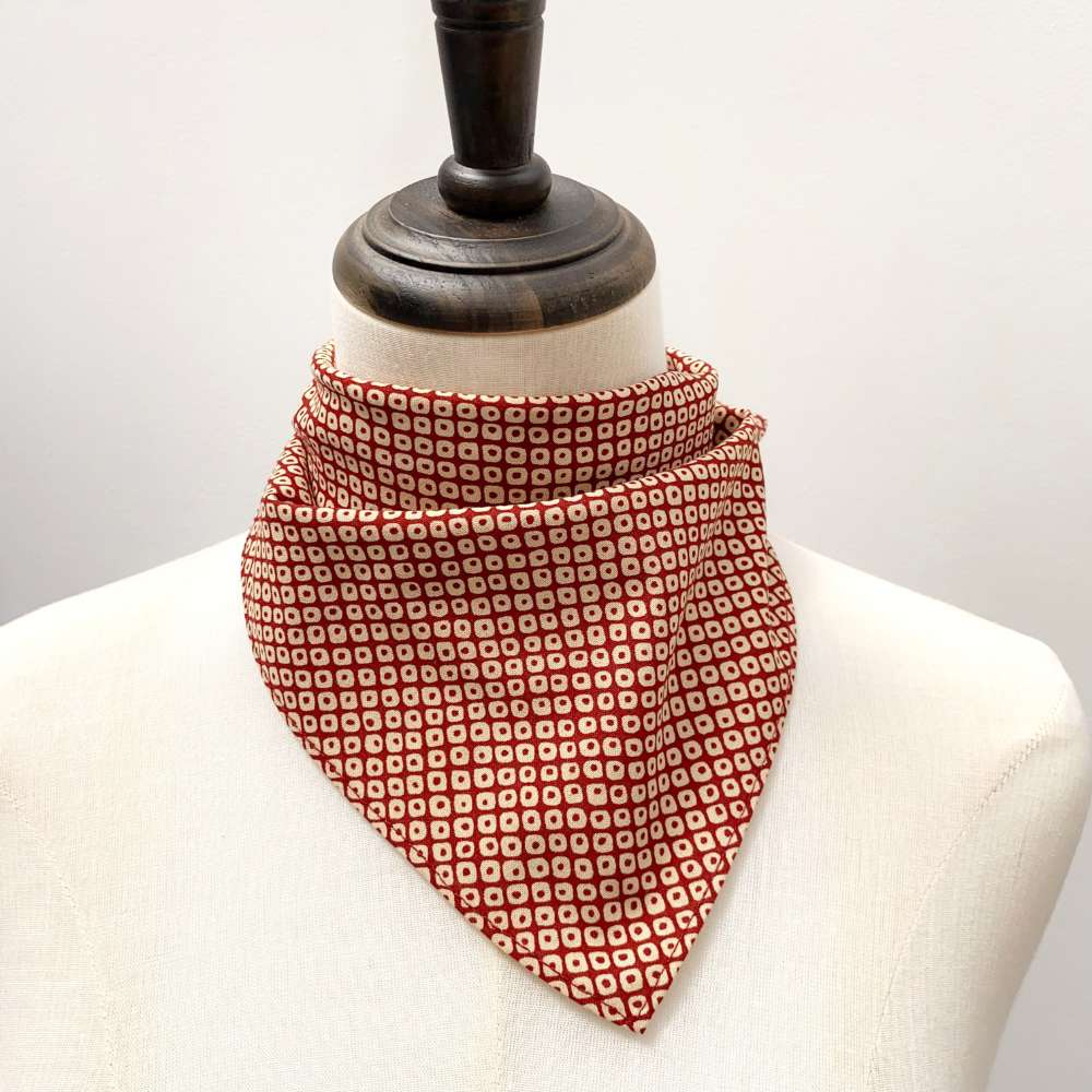 Red Kanoko Japanese cotton bandana tied as a neckerchief on a mannequin