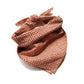 Red Kanoko Japanese cotton bandana folded and tied as a headscarf, flat lay