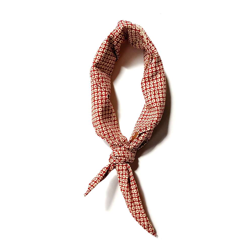 Red Kanoko cotton bandana twisted and tied, styled as a skinny scarf