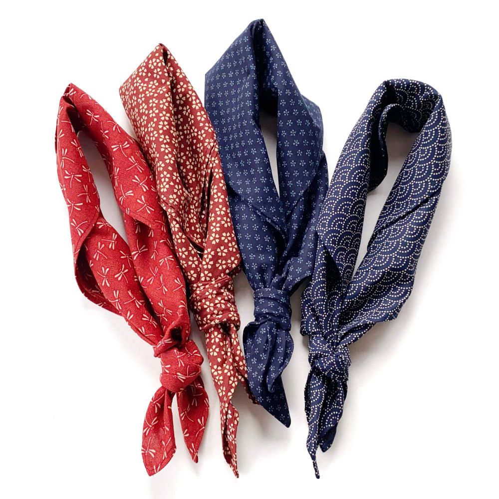 Two red and two blue Japanese wave and cherry blossom patterned cotton bandana square scarf on a white background