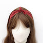 Red Japanese wave pattered bandana headband scarf worn by a mannequin head on a white background