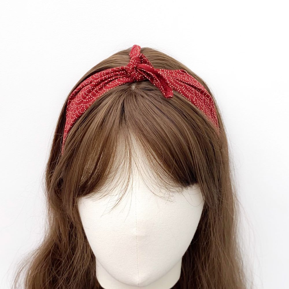 Red Japanese wave pattered bandana headband scarf worn by a mannequin head on a white background