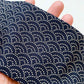 A close-up of a navy blue japanese wave cotton headband