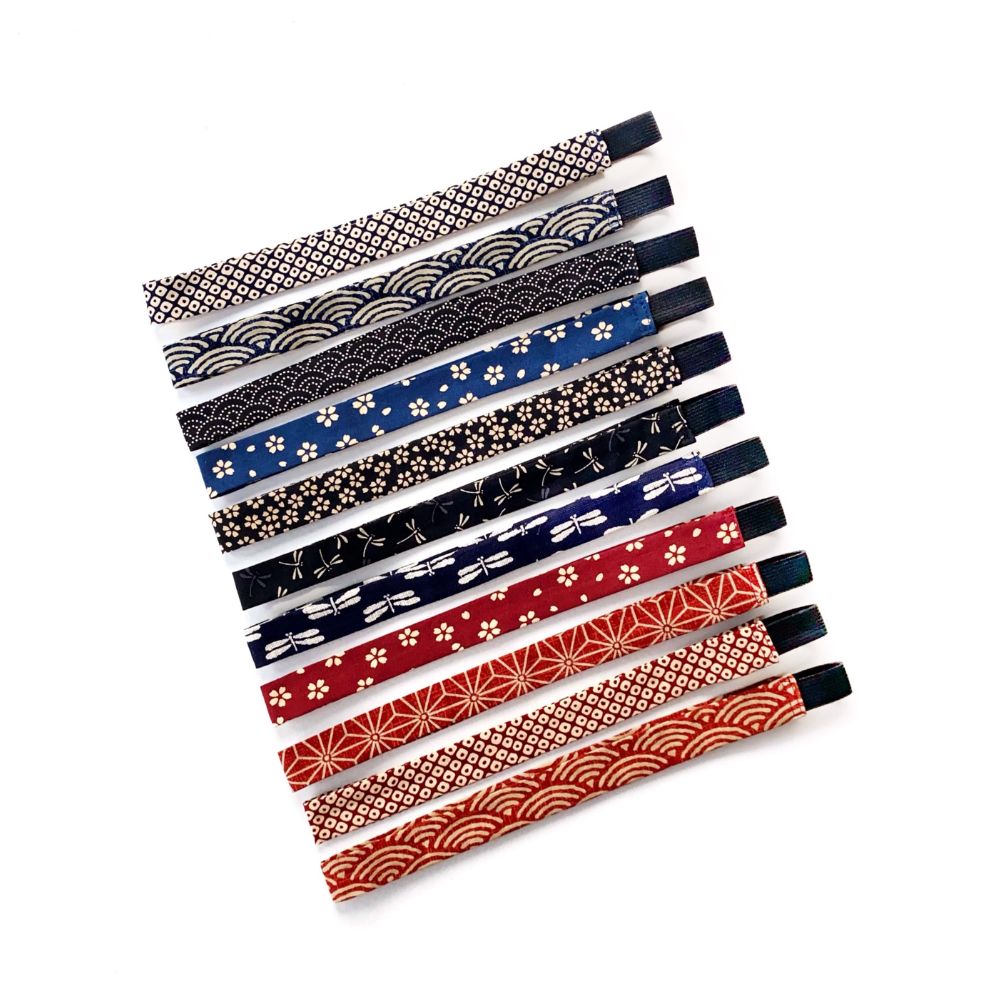Set of colorful skinny headbands with various Japanese patterns on a white background