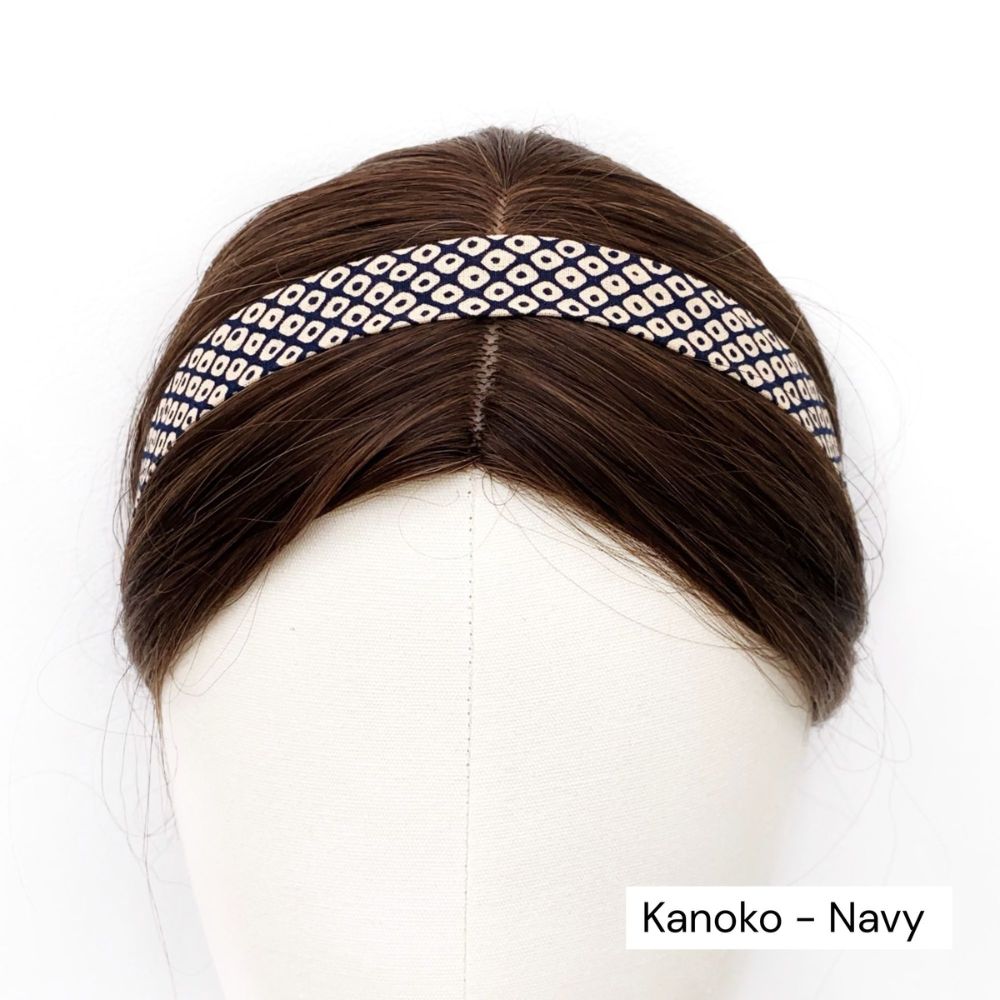 Navy cotton skinny headband with white pattern on a mannequin head against a white background