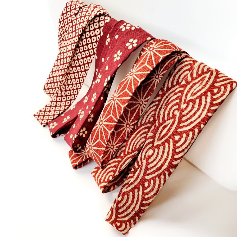 Red and white Japanese patterned cotton skinny headbands on a white background