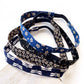 Set of blue and black cotton skinny  headbands with floral and dragonfly patterns on a white surface