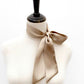 taupe beige mulberry silk satin skinny scarf tied around mannequin's neck