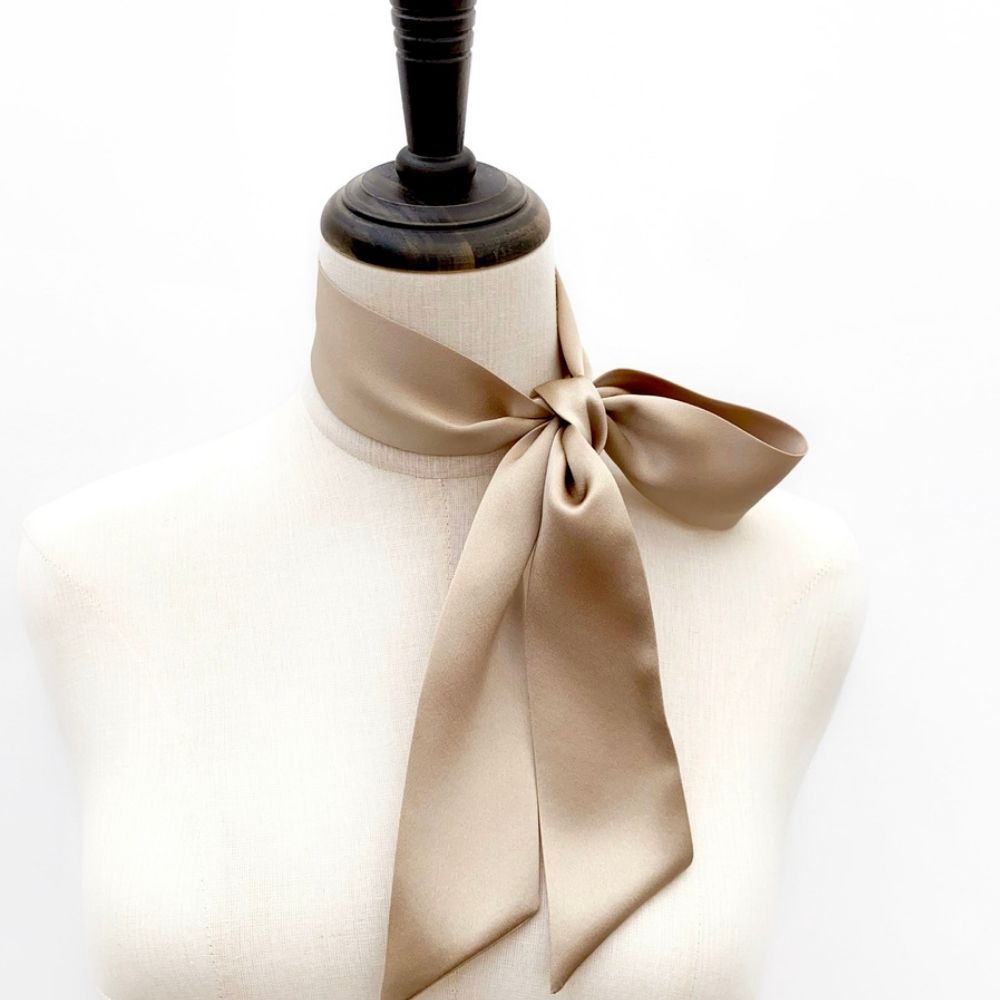 taupe beige mulberry silk satin skinny scarf tied around mannequin's neck
