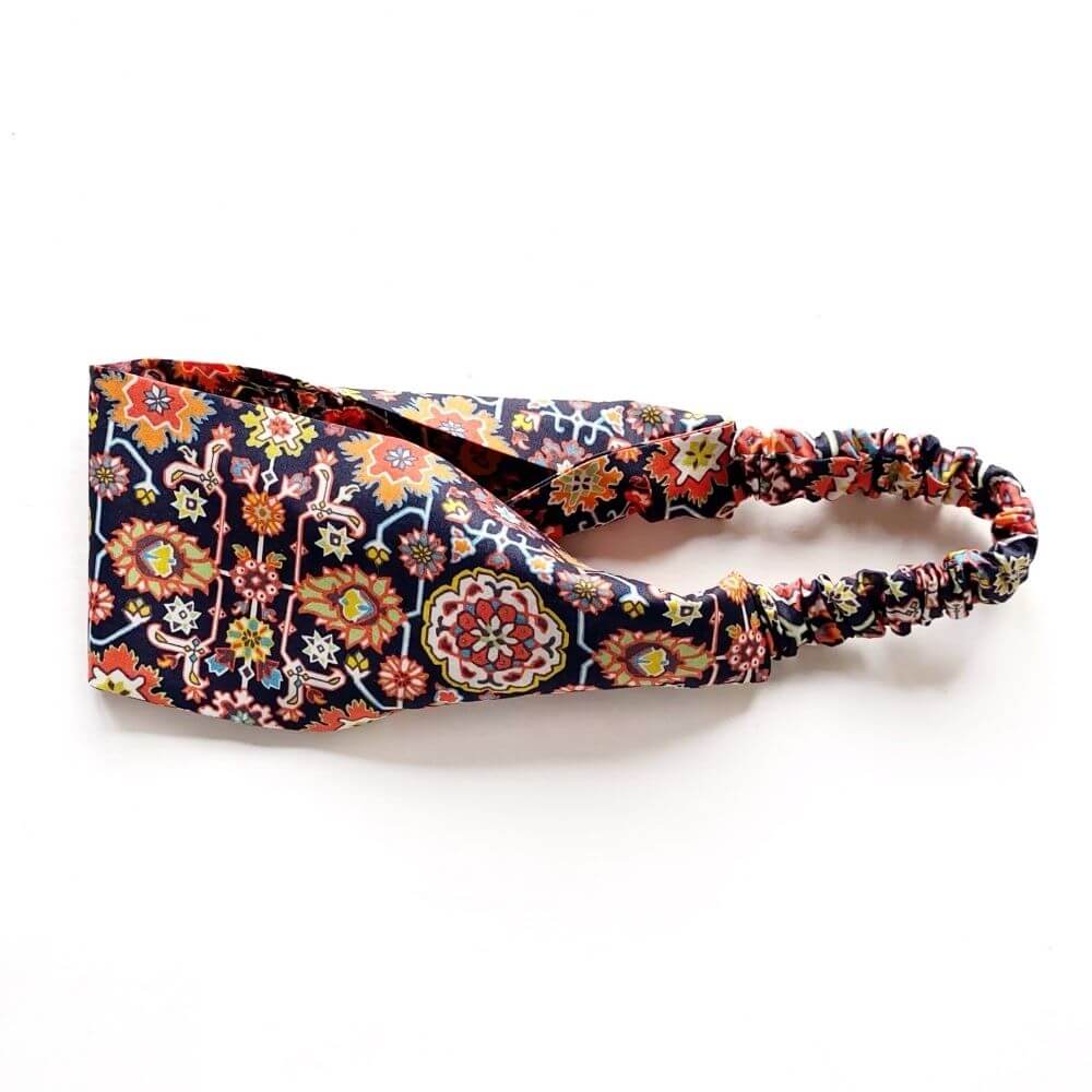 Flat-lay of the Liberty Cecil print cotton headband, highlighting the 8 cm wide front band and gathered elastic back.