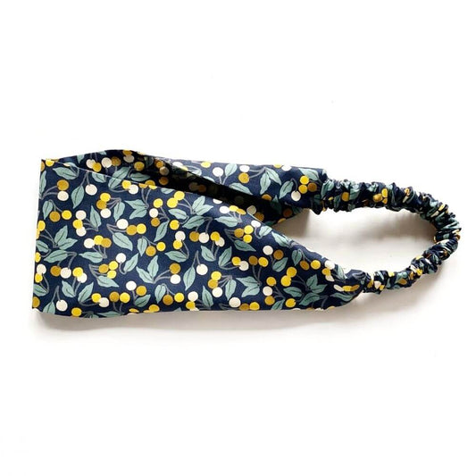 Flat-lay of the Liberty Cherry Drop print cotton headband, showing the wide front band and gathered elastic back.