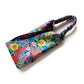 Liberty Ciara floral cotton headband arranged in a curved shape, showing the elastic back and vibrant multicolour design.