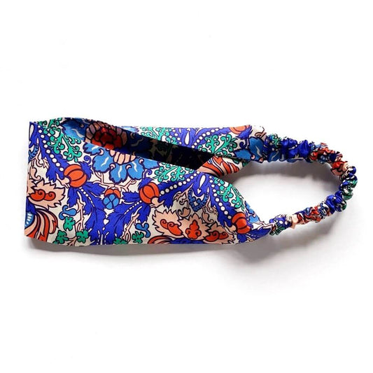 Flat-lay of the Liberty Electric Nouveau cotton headband, highlighting the mirrored ornamental print and wide 8 cm band.