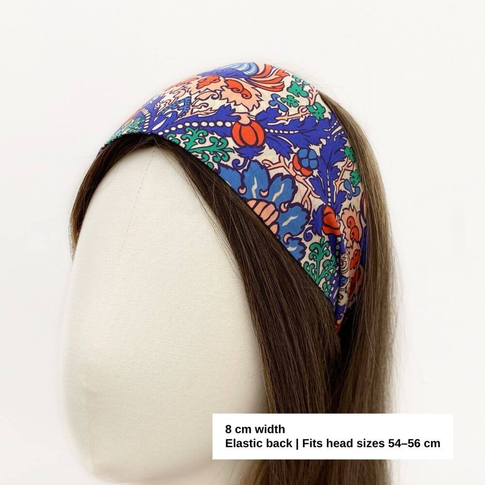 Liberty Electric Nouveau cotton headband displayed on a mannequin, showing the ornate floral pattern and comfortable elasticated fit.