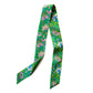 Colorful floral-patterned Liberty silk twilly scarf on a white background