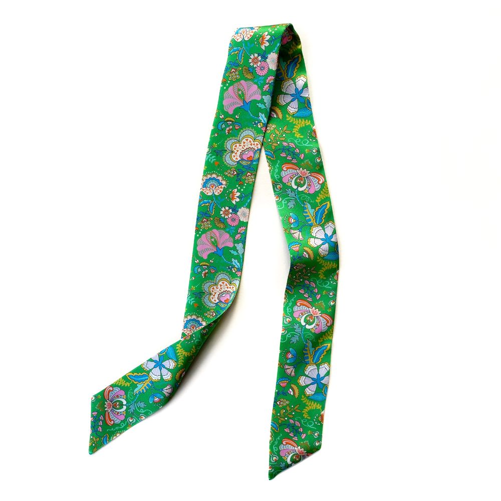 Colorful floral-patterned Liberty silk twilly scarf on a white background