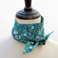 Floral print Liberty silk skinny scarf tied on a mannequin's neck with a white background