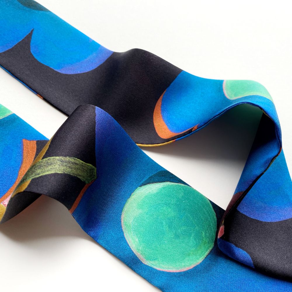 Colorful Liberty silk skinny necktie with abstract pattern on a white background