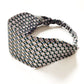 Liberty London Tana Lawn cotton headband with a geometric pattern of interlocking circles in black, white, and olive green, featuring an elasticized back band, shown on a plain white background.