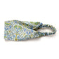 A Liberty London Tana Lawn cotton headband in william morris print" lodden" with a green, blue, and white floral pattern, featuring an elastic band, shown on a plain white background.